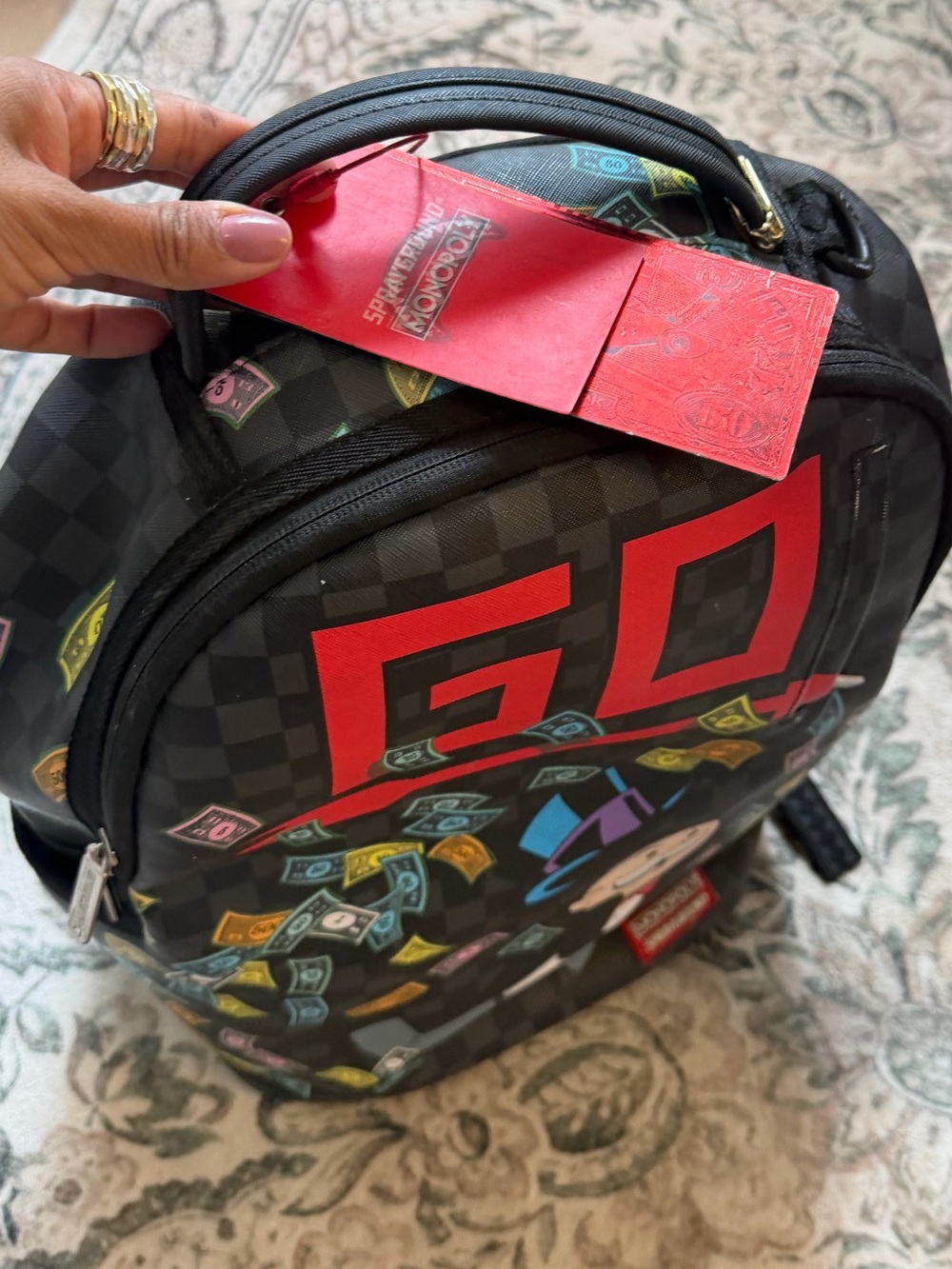 Sprayground Black Backpack with Red GO Logo and Multicolor monopoly Print